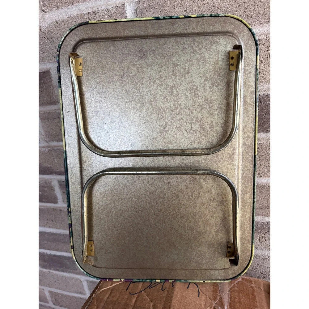 Vintage metal TV tray set features a vibrant 1960s or 70s floral pattern